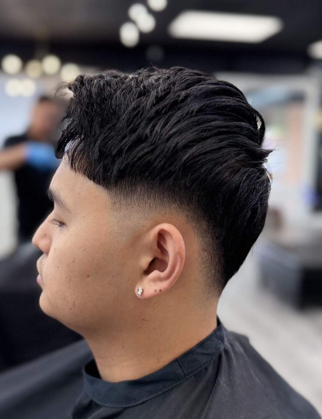 Low taper fade with brushed back waves
